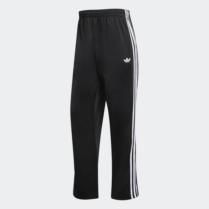 Black Adidas Firebird track pants with white three-stripes and Trefoil logo, shown from a slightly angled view.