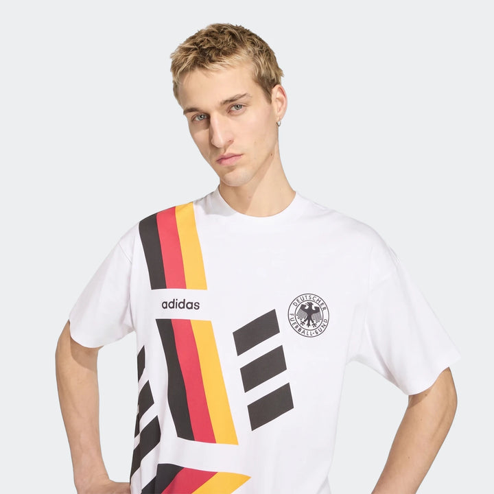 Young male model wearing a white Adidas Germany 1994 short sleeve T-shirt with DFB crest and German flag stripe graphics.