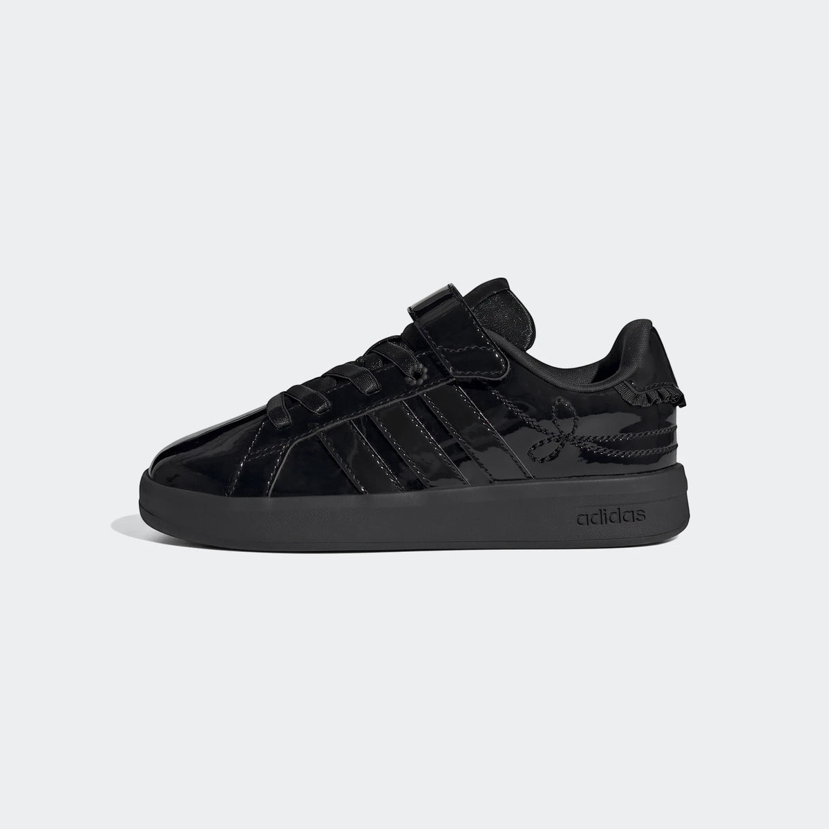 Side view of black patent leather Adidas Grand Court 3.0 girls' shoes with a velcro strap and laces.