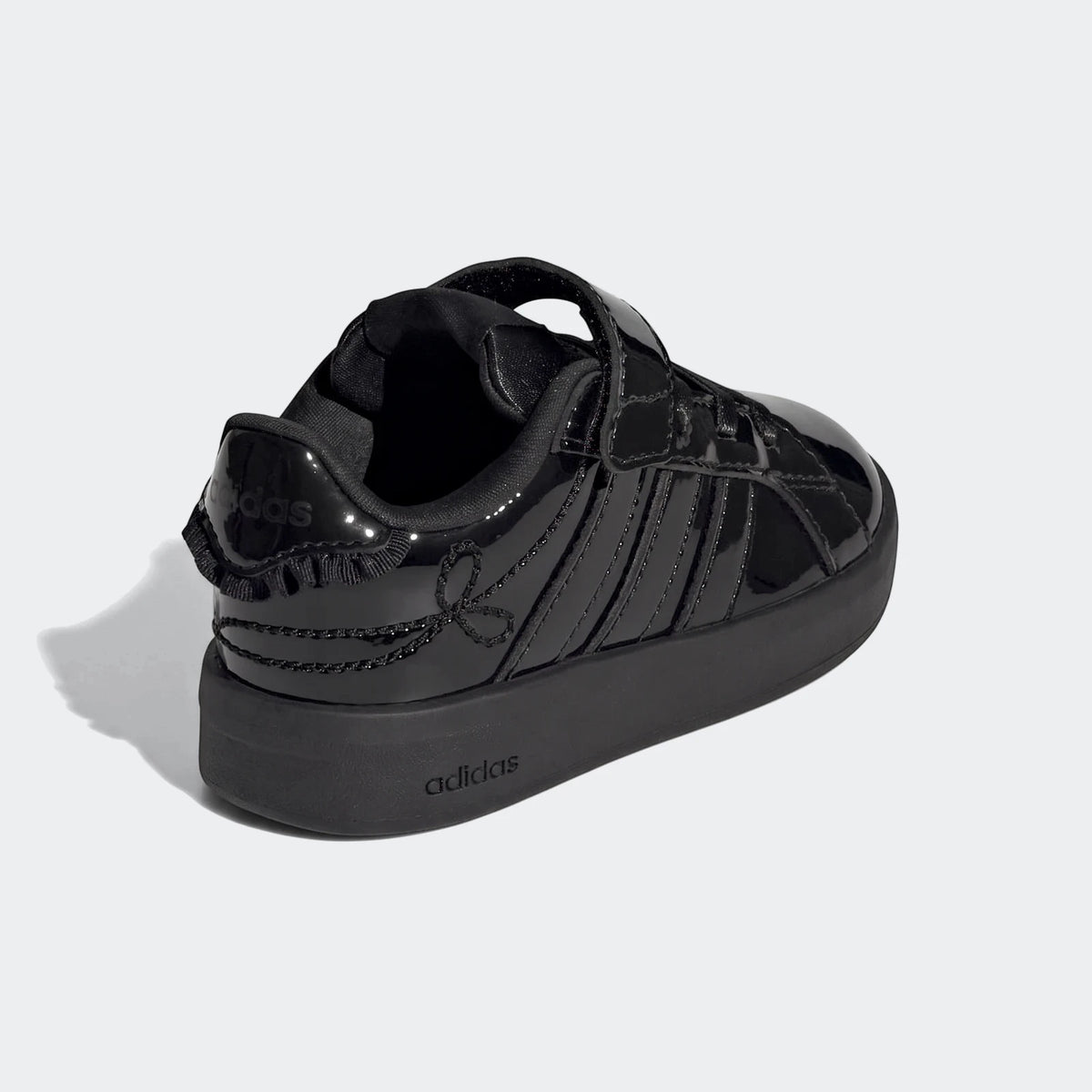 Black patent leather Adidas Grand Court 3.0 infant girls' shoes with velcro closure, shown from a rear-right angle.