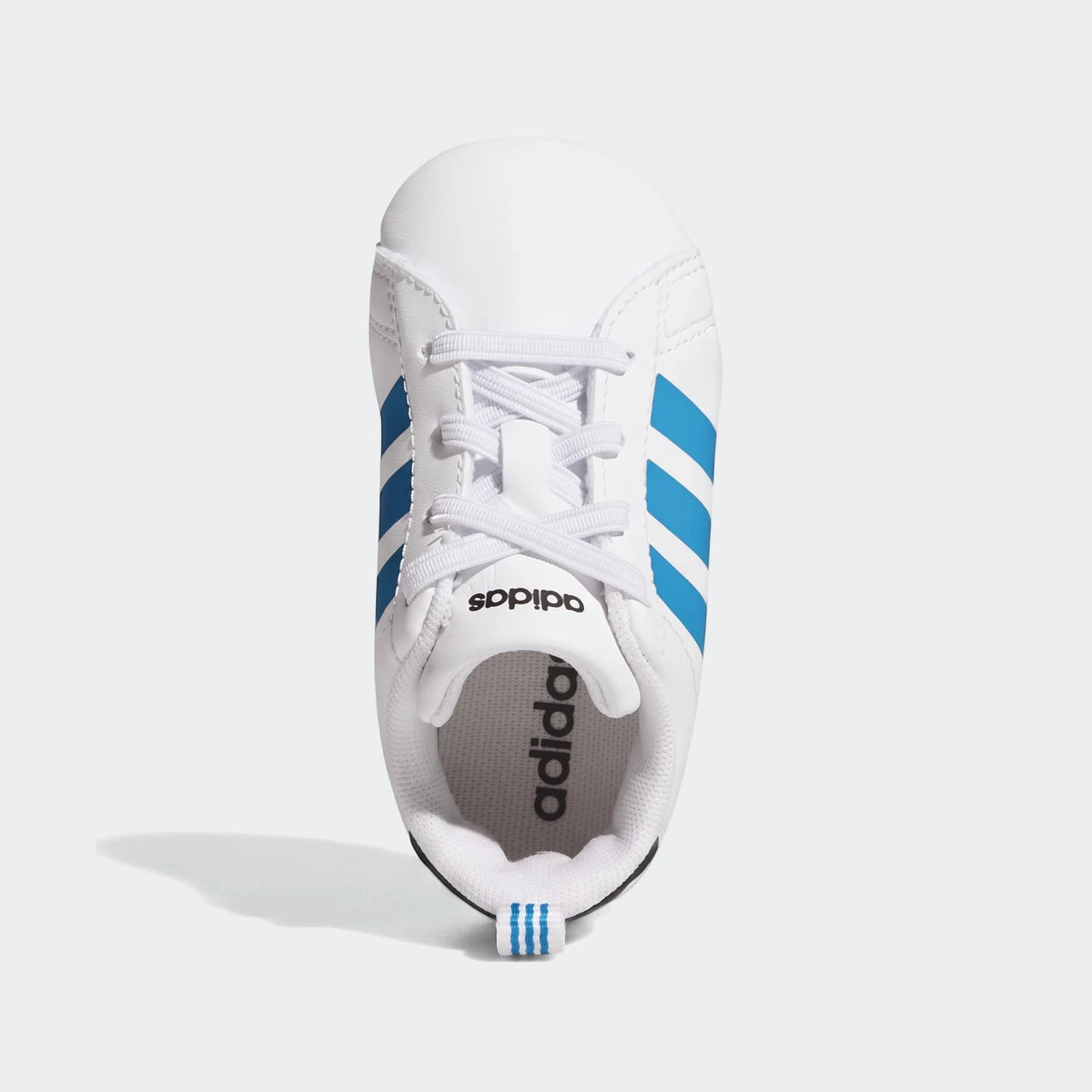 Top-down view of a white Adidas Grand Court baby crib shoe with three blue stripes and white laces.