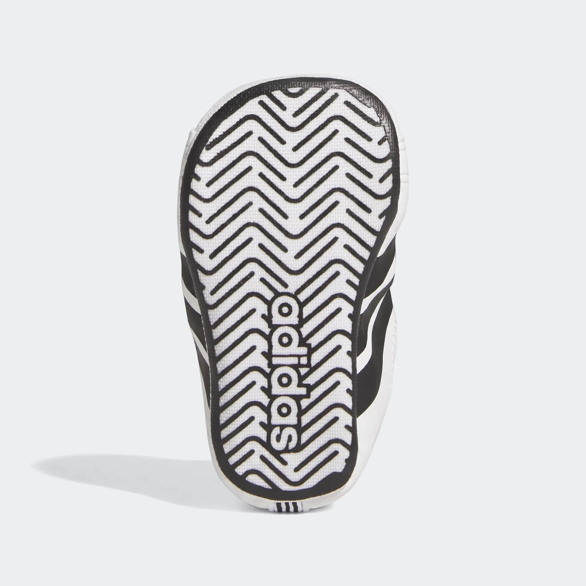Adidas Grand Court Crib infant shoes, presented in black and white. The image shows the bottom sole with a distinct zigzag
