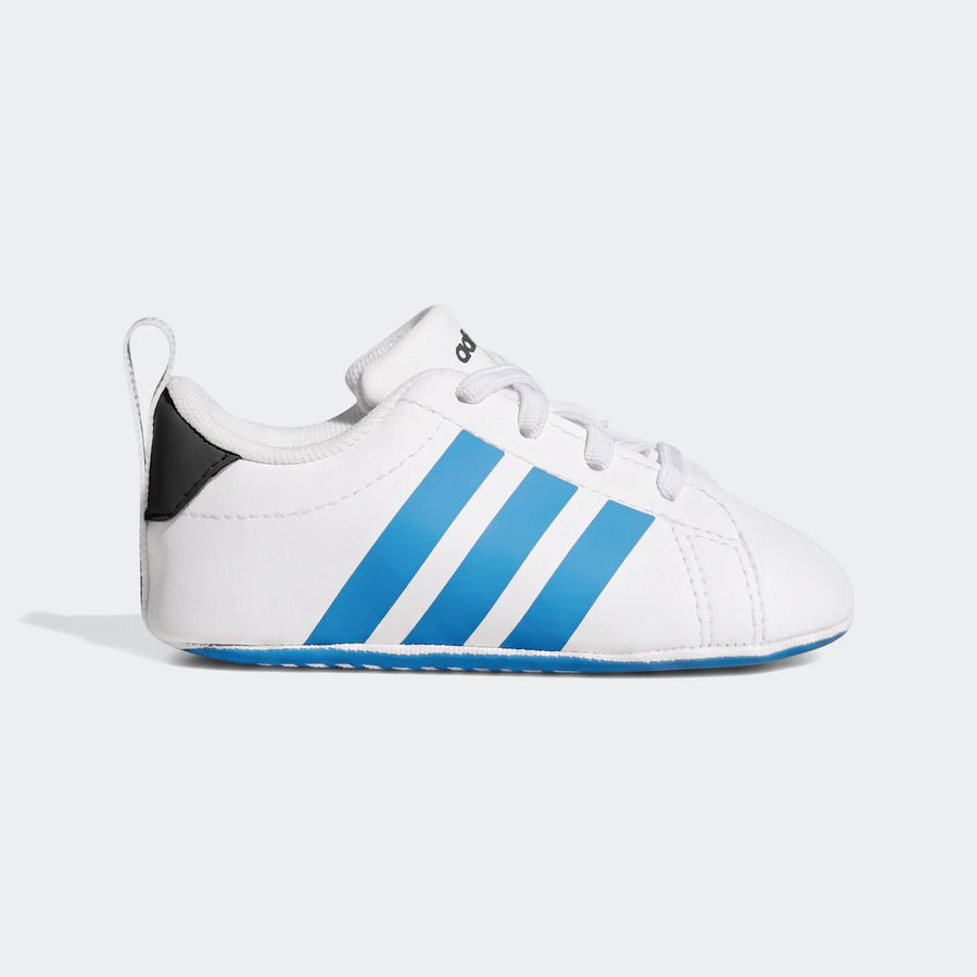 Side view of white Adidas Grand Court crib shoes with three blue stripes and white laces, perfect for infants.