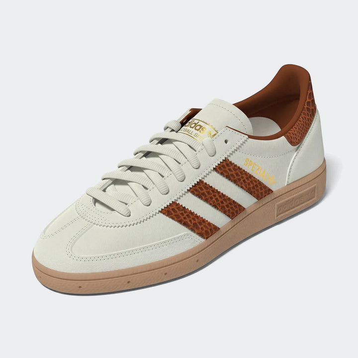 Cream Adidas Handball Spezial low-top sneakers with brown snakeskin-patterned stripes and heel tab, featuring a brown gum