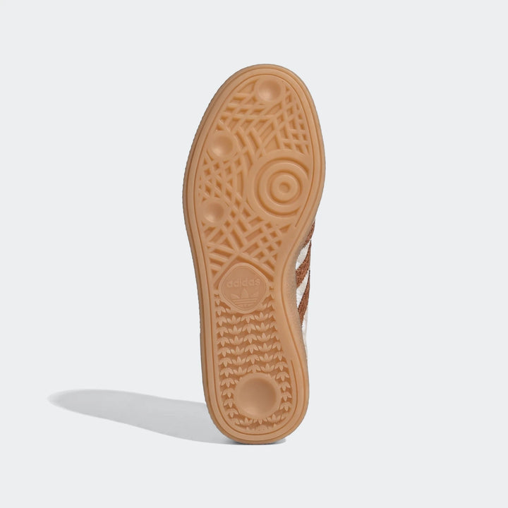 View of the textured gum rubber sole of the Adidas Handball Spezial Shoes, featuring the iconic trefoil logo and signature