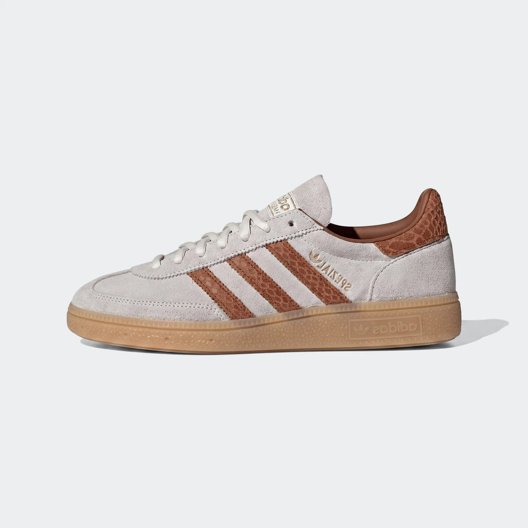 Adidas Handball Spezial Shoes in light grey suede with brown stripes and a gum rubber sole, displayed in a side view.