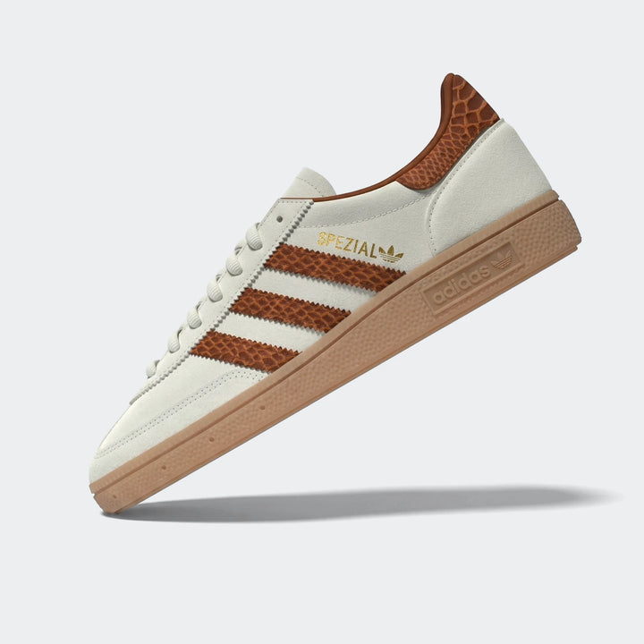 Off-white and brown Adidas Handball Spezial shoes, featuring textured stripes and heel tab, with a tan gum sole and gold