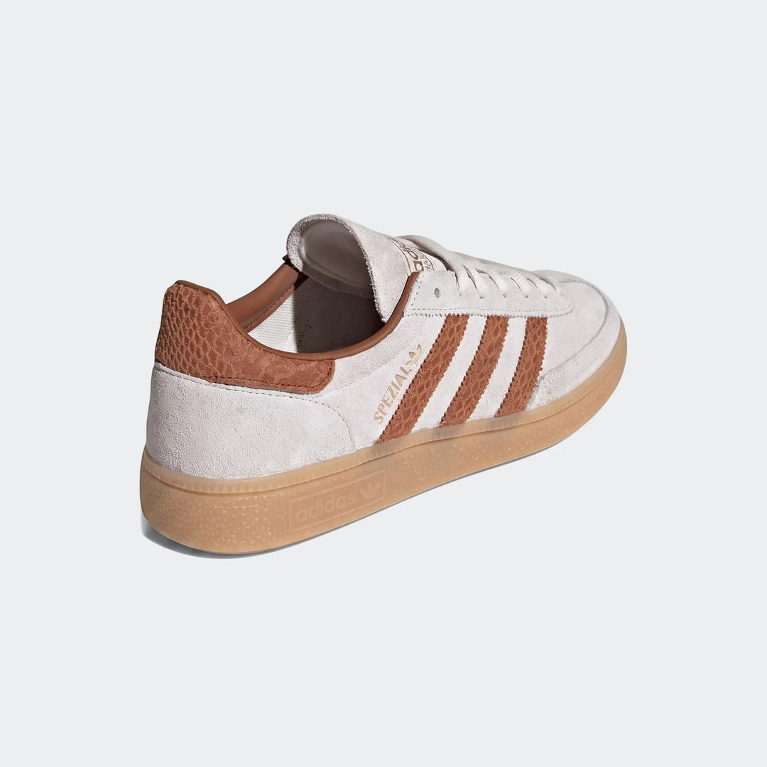 Off-white Adidas Handball Spezial shoes with brown stripes and a gum sole, viewed from the side.