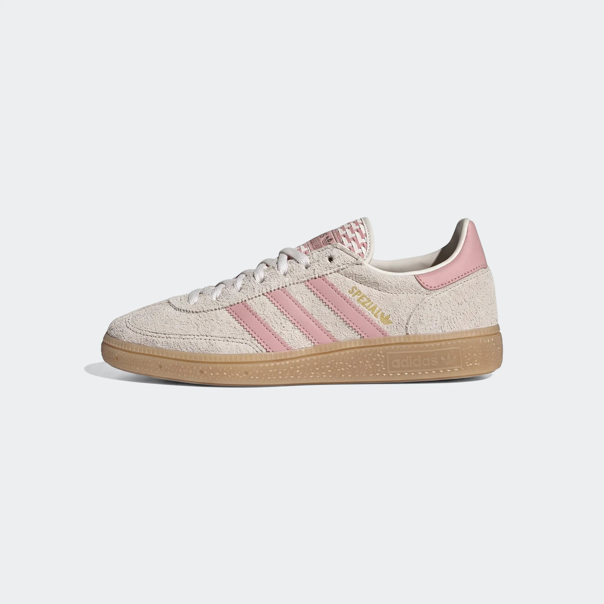 Adidas Handball Spezial Shoes in off-white suede with pink stripes and a gum sole, shown in a side profile view.