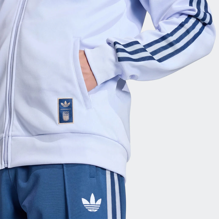 Adidas Italy Originals Track Top in light blue and royal blue track pants on a model, highlighting embroidered logos and