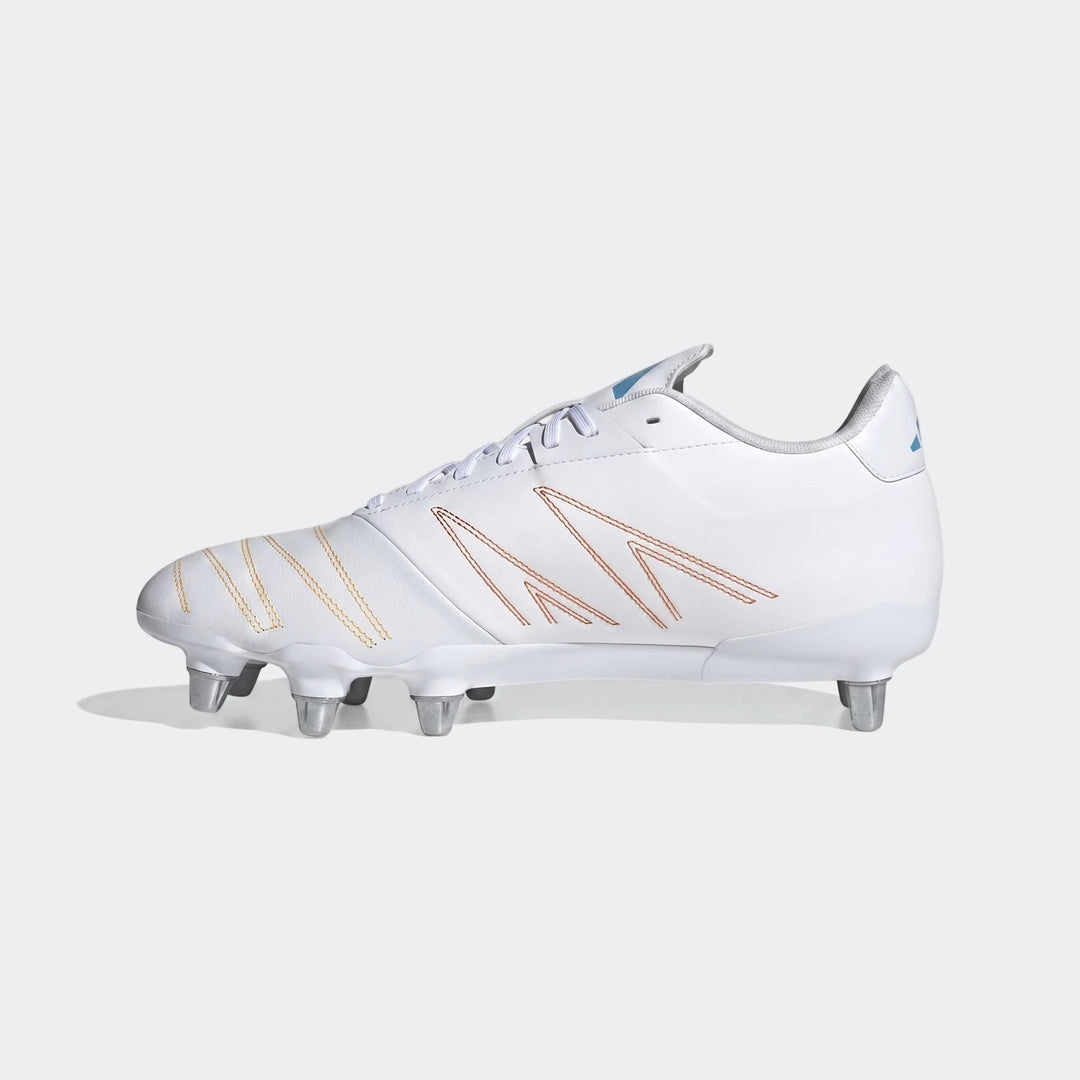 White Adidas Kakari Elite Sg Rugby Boots with orange and yellow stitching and silver studs, shown from a side view.