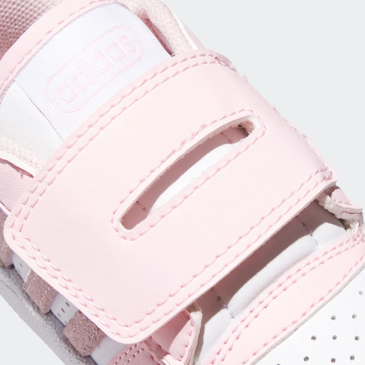 Close-up of a pink and white Adidas Kids Break Start shoe, featuring a velcro strap and subtle branding.