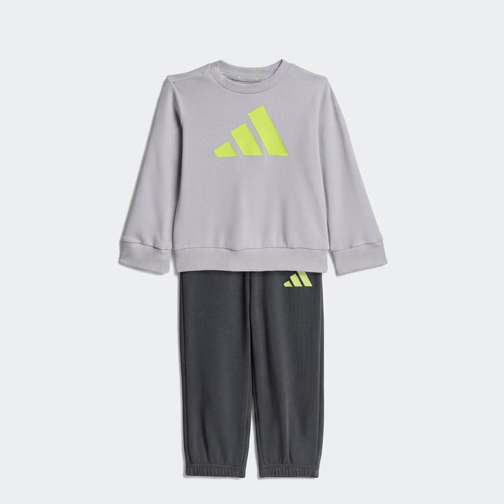 Kid's Adidas Essentials Joggers Set featuring a light gray long-sleeve sweatshirt with a neon yellow Adidas logo and dark