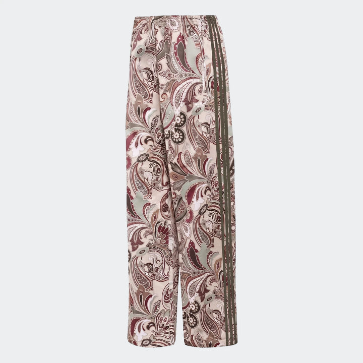 Adidas Liberty London Firebird satin trackpants in an all-over beige and burgundy paisley print with dark green side