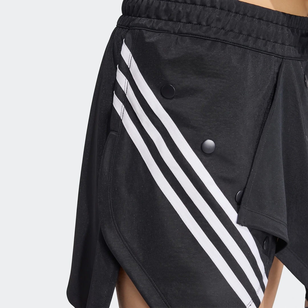 Close-up of a black Adidas X Mia Marquez mini skirt with iconic white three stripes and black snap buttons, showing texture.