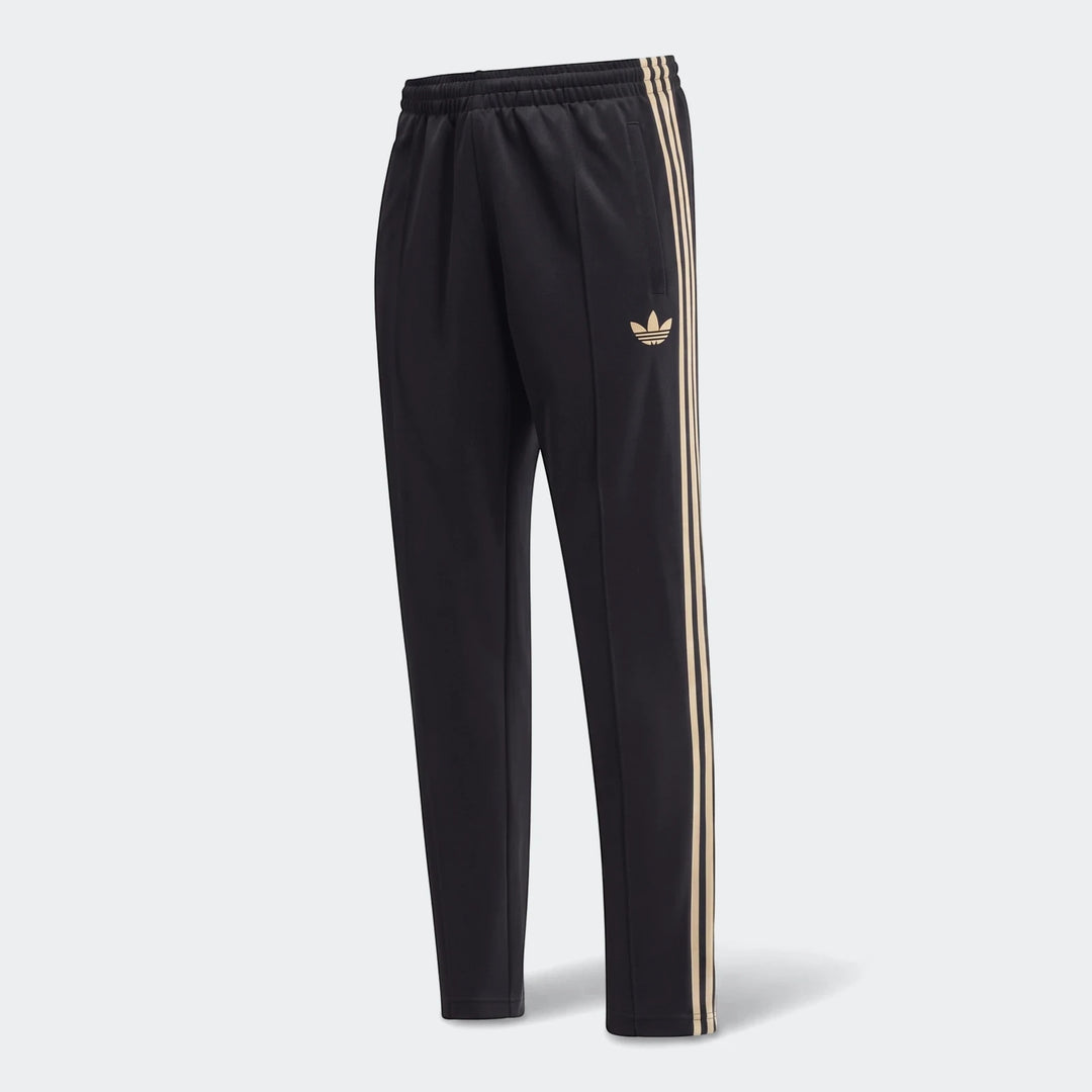 Black Adidas Op Og2 Tp track pants featuring iconic gold three-stripes and a Trefoil logo, presented vertically.