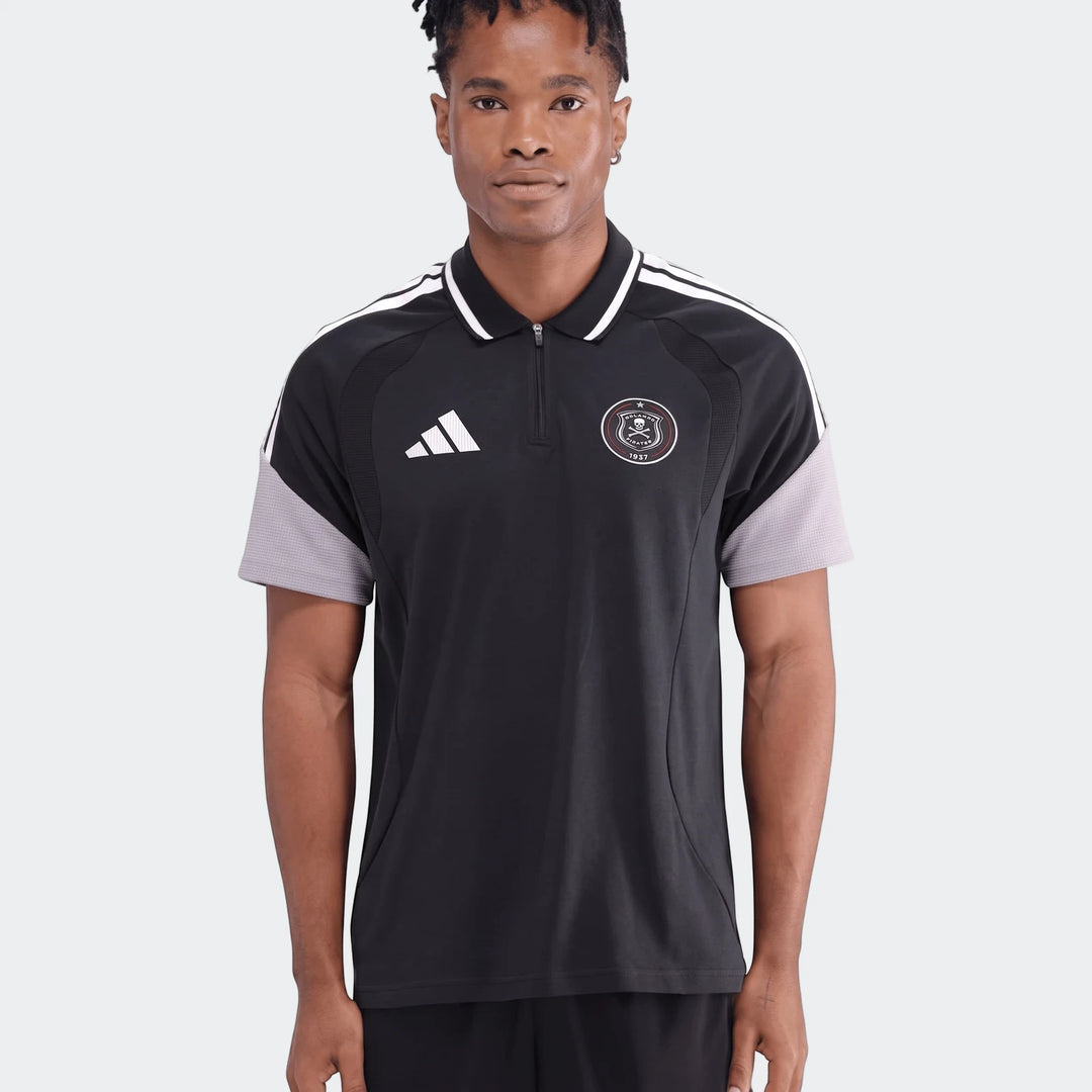 Black Adidas Op Tiro26C Polo shirt on a male model, featuring white shoulder stripes and an Orlando Pirates logo, front view.