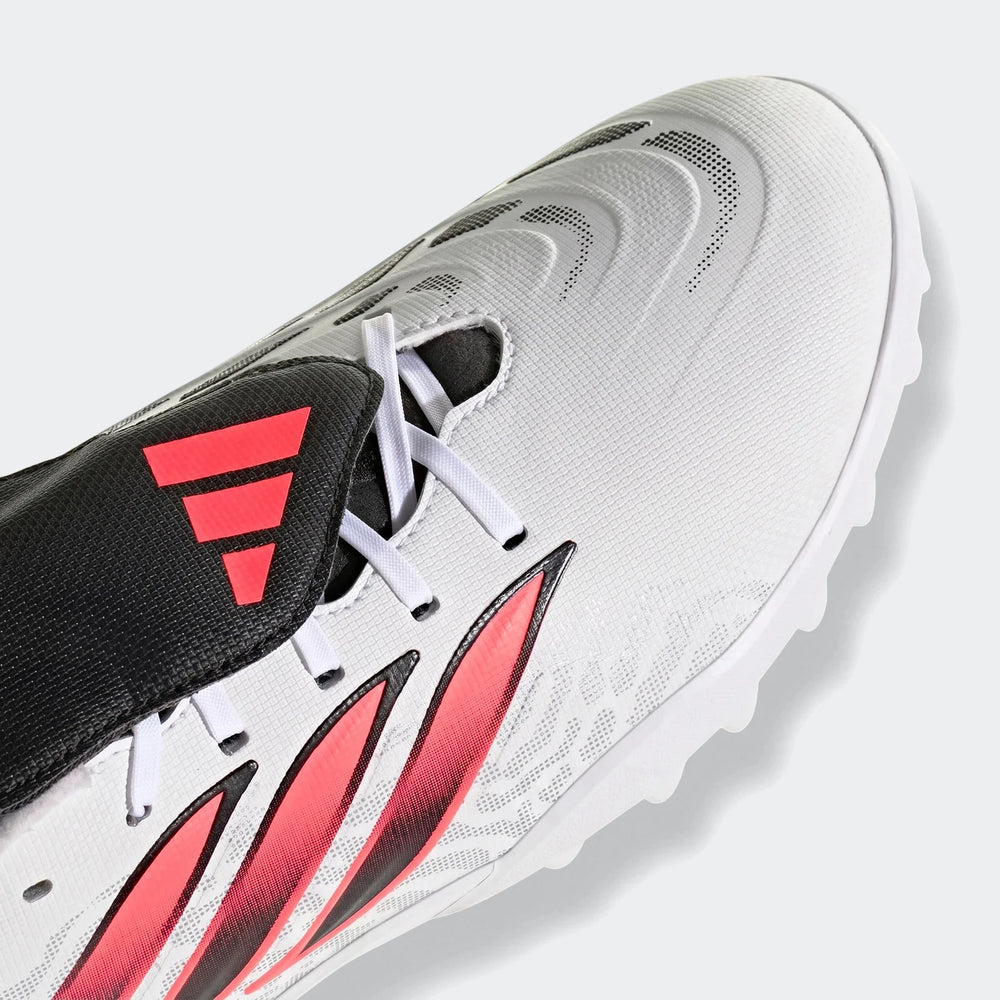 Close-up of a white, black, and coral Adidas Predator Club Fold-Over Tongue Turf Football Boot, showing the textured upper