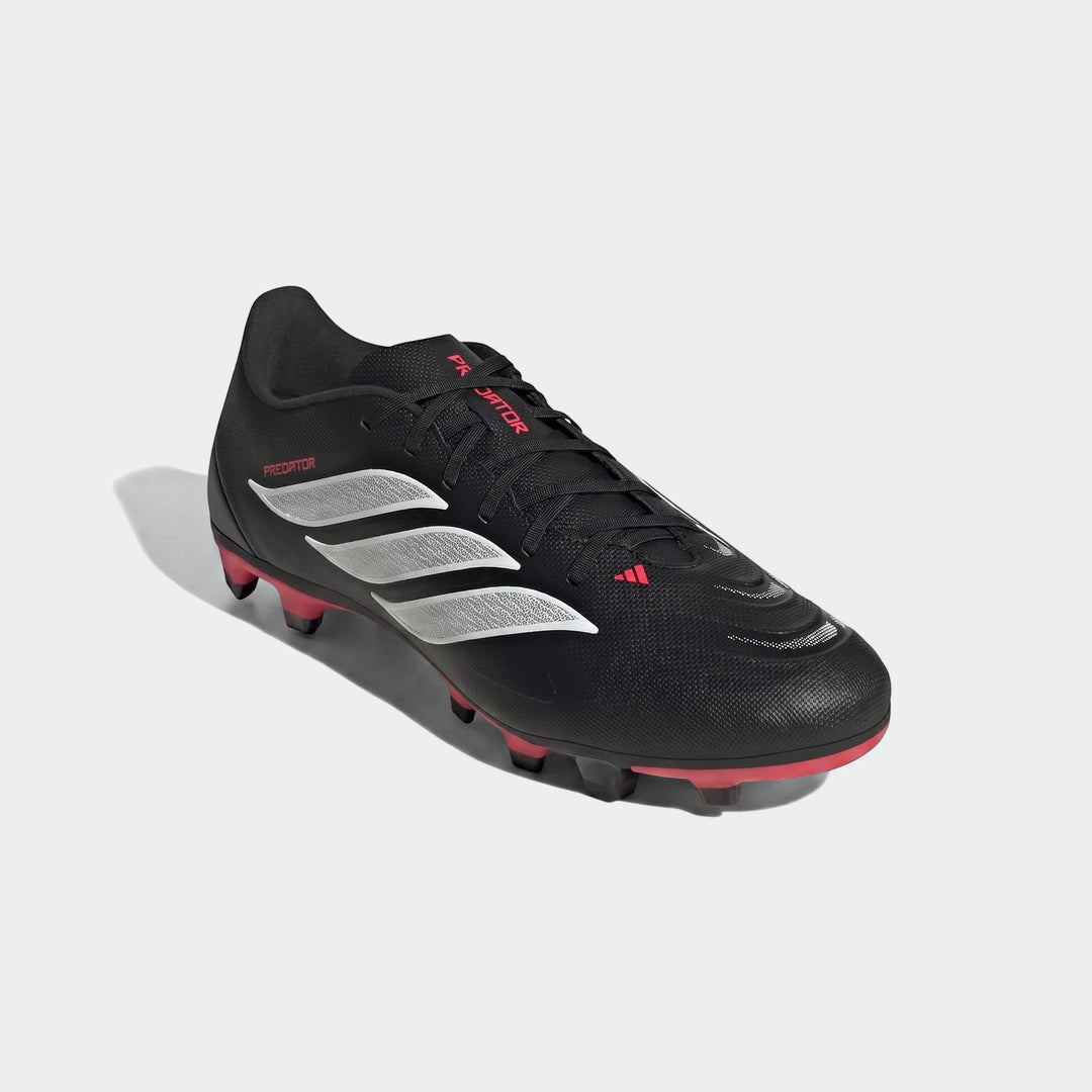 Black Adidas Predator Club firm ground football boot with silver stripes and pink accents, shown from an angled side view.