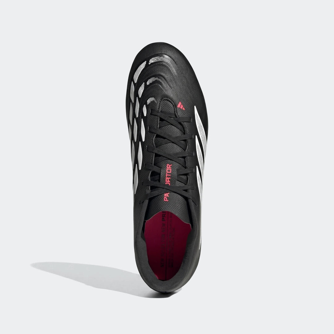 Black and white Adidas Predator Club football boots with pink accents, shown from a top-down perspective.