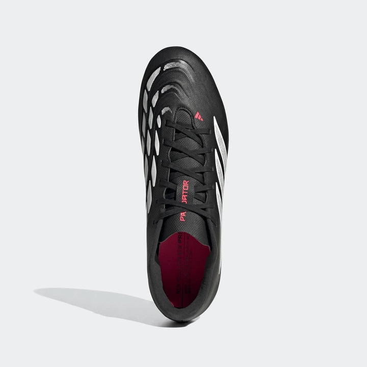 Black and white Adidas Predator Club football boots with pink accents, shown from a top-down perspective.