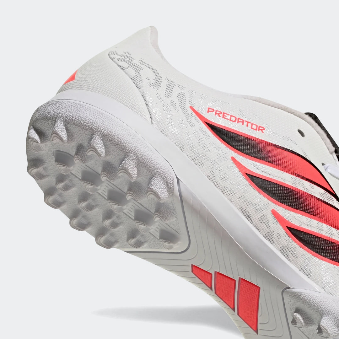 White and red Adidas Predator Club Fold-Over Tongue turf football boot, close-up shot of the sole and heel.