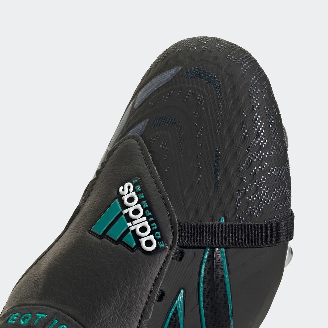 Close-up of a black and teal Adidas Predator Elite Ft Fg Eqt football boot, featuring the Adidas Equipment logo and textured
