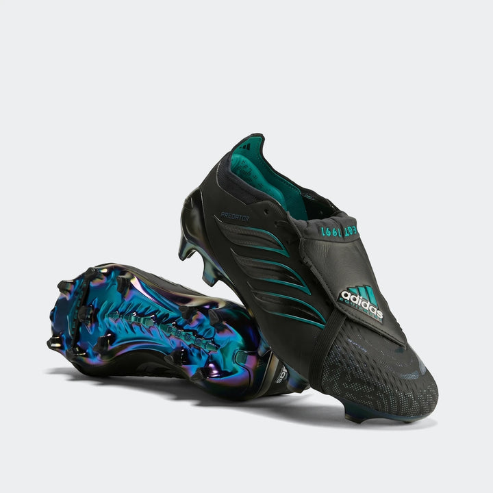 Pair of black Adidas Predator Elite FT FG EQT football boots with teal accents and iridescent blue-green soles, displayed at