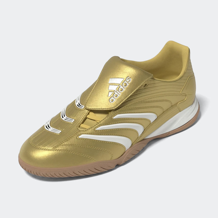 Gold Adidas Predator Sala indoor football boots with white stripes and a tan sole, viewed from a high angle.