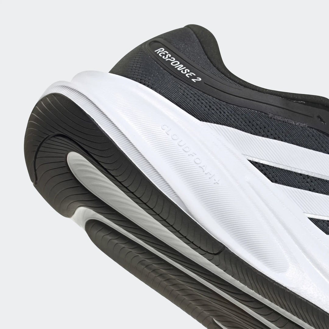 Close-up of the black and white Adidas Response 2 running shoes, showcasing the heel and sole details.