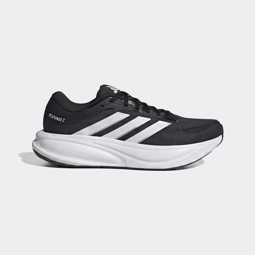 Black and white Adidas Response 2 running shoes, side view, featuring white stripes and a thick cloudfoam sole.