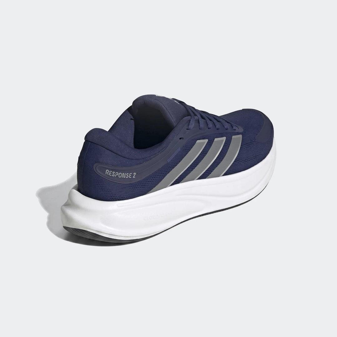 Navy blue Adidas Response 2 running shoes with silver stripes and a white sole, shown from a side-rear view on a plain
