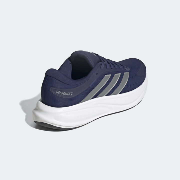 Navy blue Adidas Response 2 running shoes with silver stripes and a white sole, shown from a side-rear view on a plain