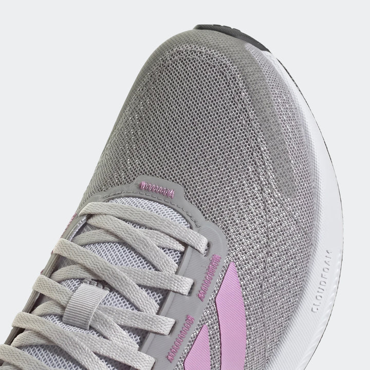 Close-up view of a grey and pink Adidas Runblaze W running shoe, showcasing the mesh upper, laces, and sole details.