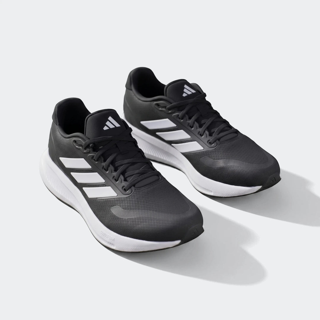 Pair of black Adidas Runfalcon 5 running sneakers with white soles and iconic white three-stripes displayed on a surface.