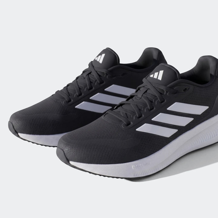 Pair of Adidas Runfalcon 5 black sneakers with white stripes and white soles, shown from a side angle.