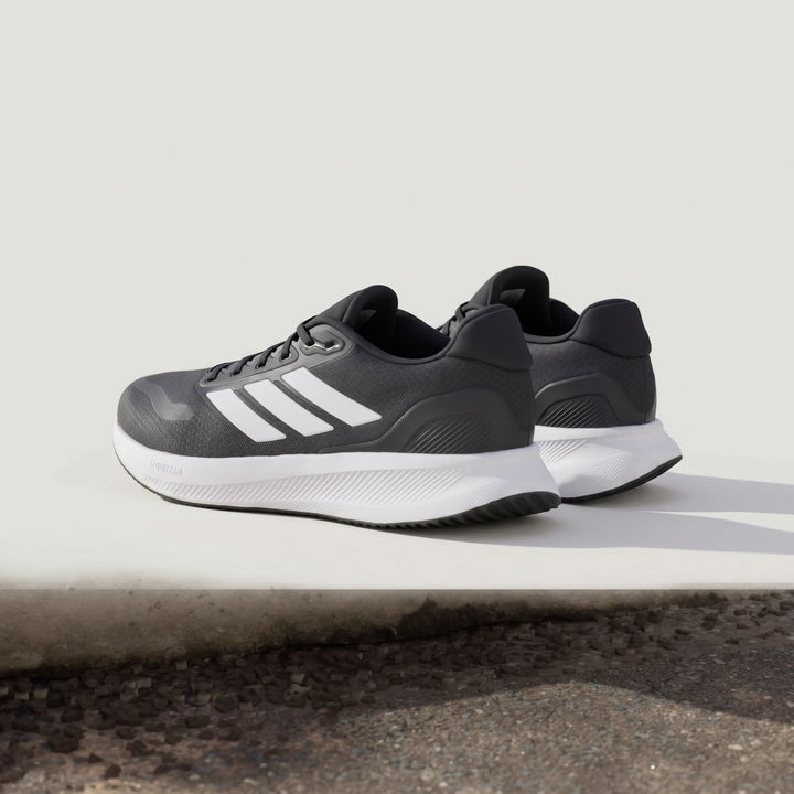 Adidas Runfalcon 5 Black Sneakers, featuring white three stripes and a white Cloudfoam midsole, in a low-angle side view.