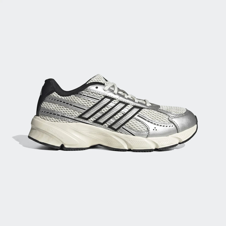 Side view of an Adidas running shoe with white mesh, silver overlays, black stripes, and a cream Cloudfoam sole.