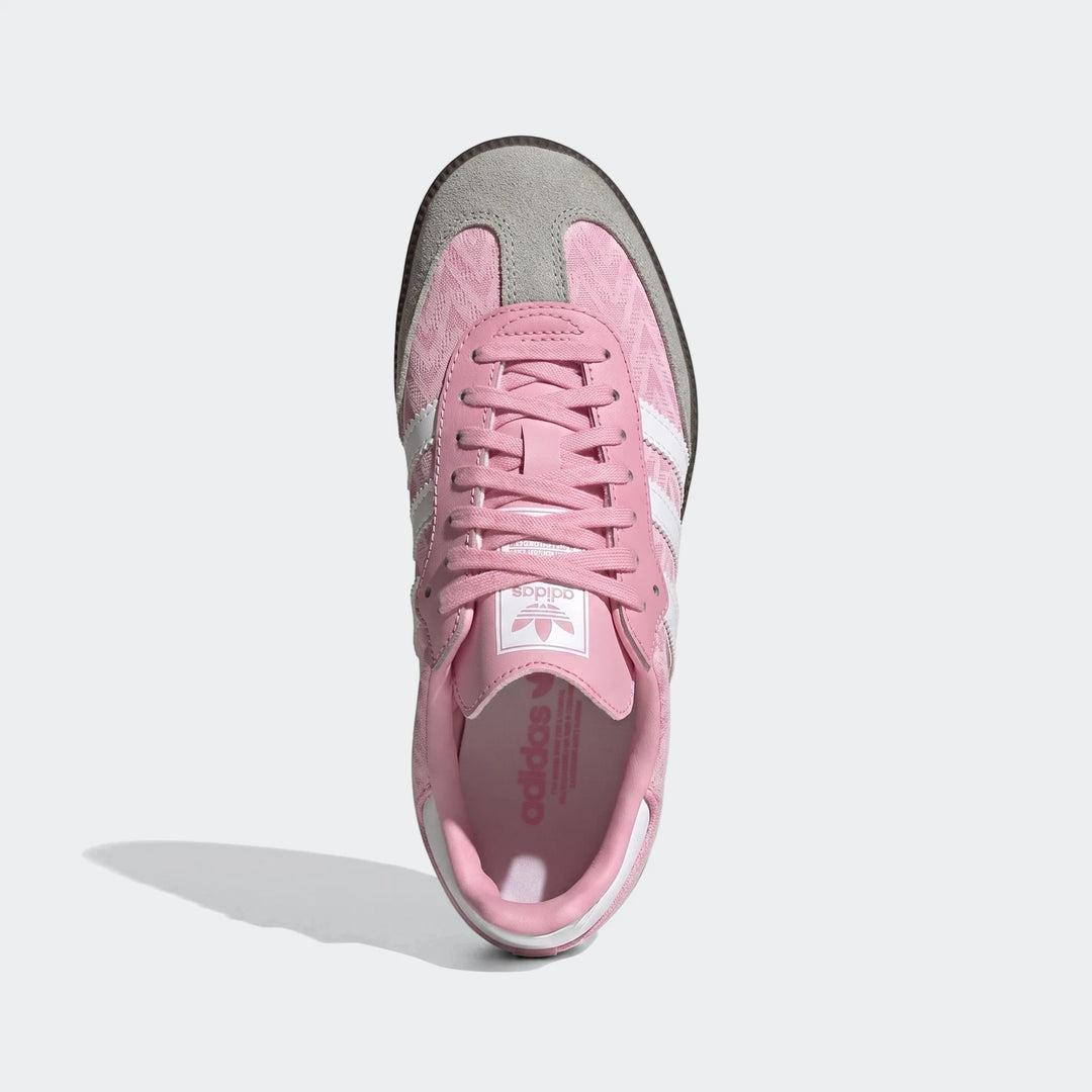 Pink and gray Adidas Samba Og Kids Shoes, presented in a top-down view, featuring white stripes and laces on a textile and