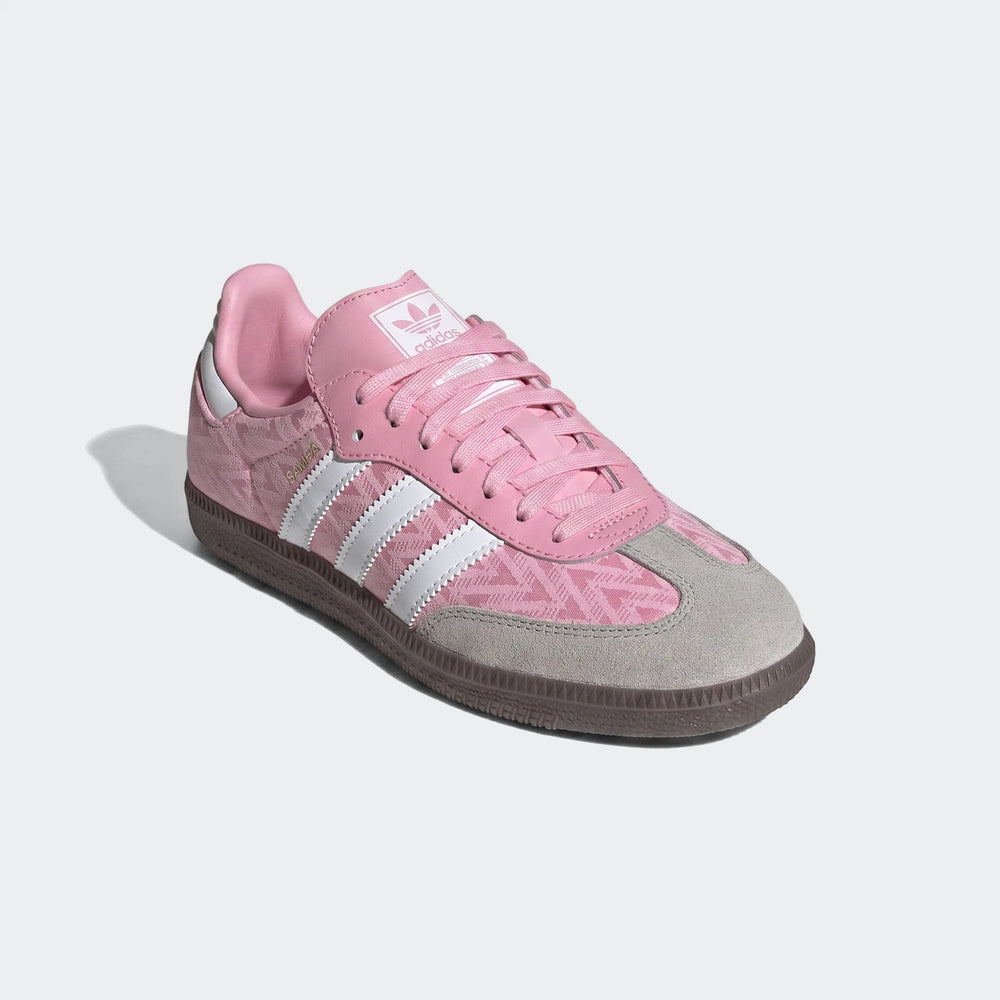 Pink and grey Adidas Samba Og Kids low-top sneakers with a patterned textile upper and suede toe cap, side view.