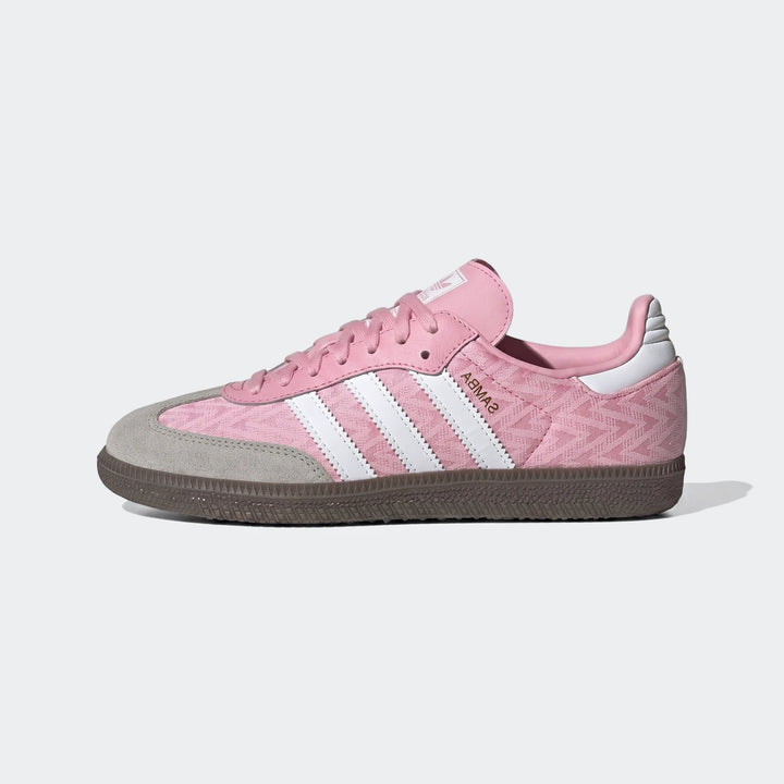 Pink Adidas Samba Og Kids Shoes with white stripes and a grey suede toe cap, shown in a side view.