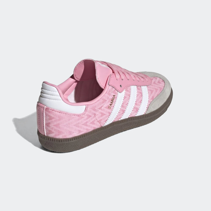 Pink Adidas Samba Og Kids Shoes with white stripes, gray suede toe, and brown rubber sole, viewed from a side-rear angle.