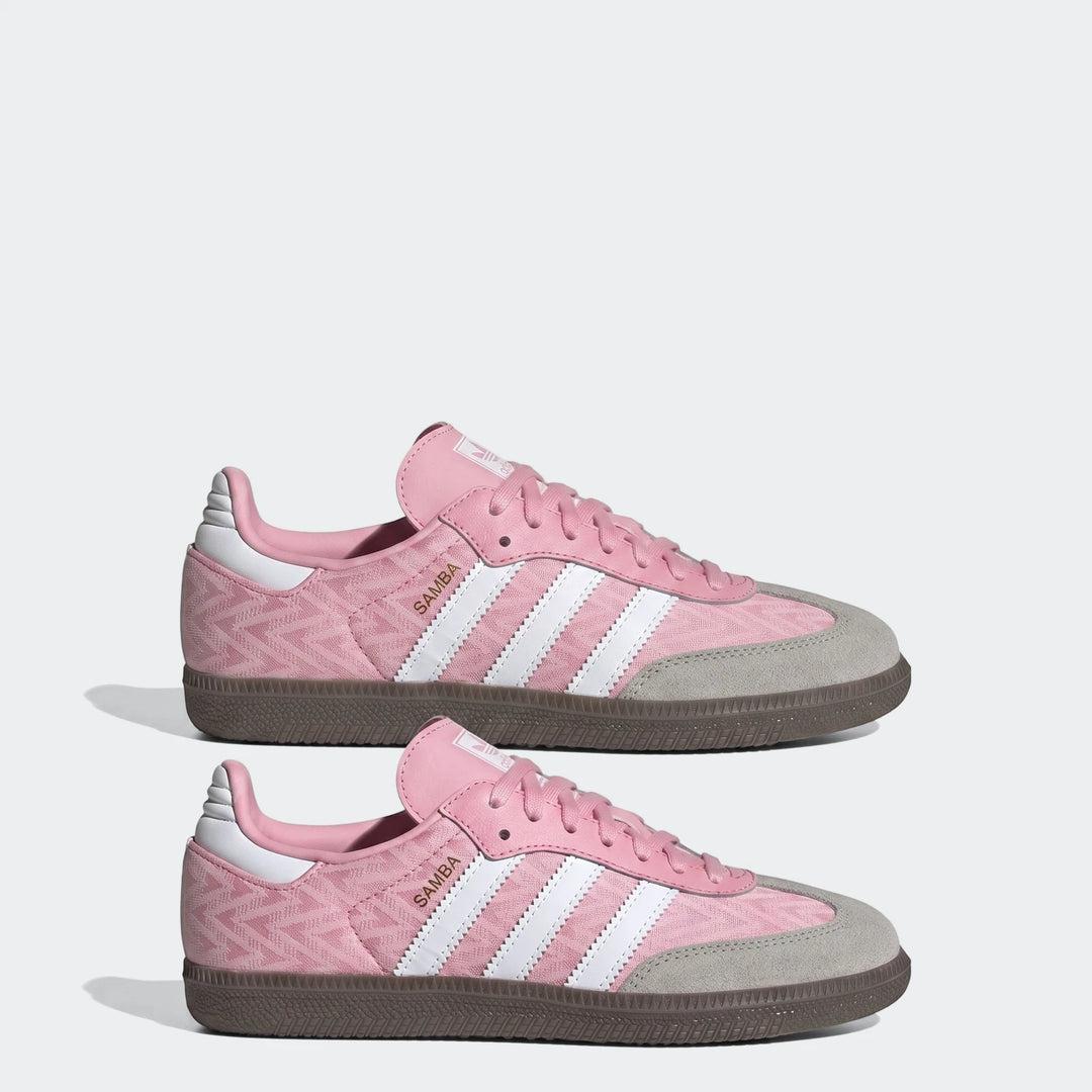 Pink Adidas Samba Og Kids Shoes with white stripes, a gray suede toe, and a brown rubber sole, viewed from the side.