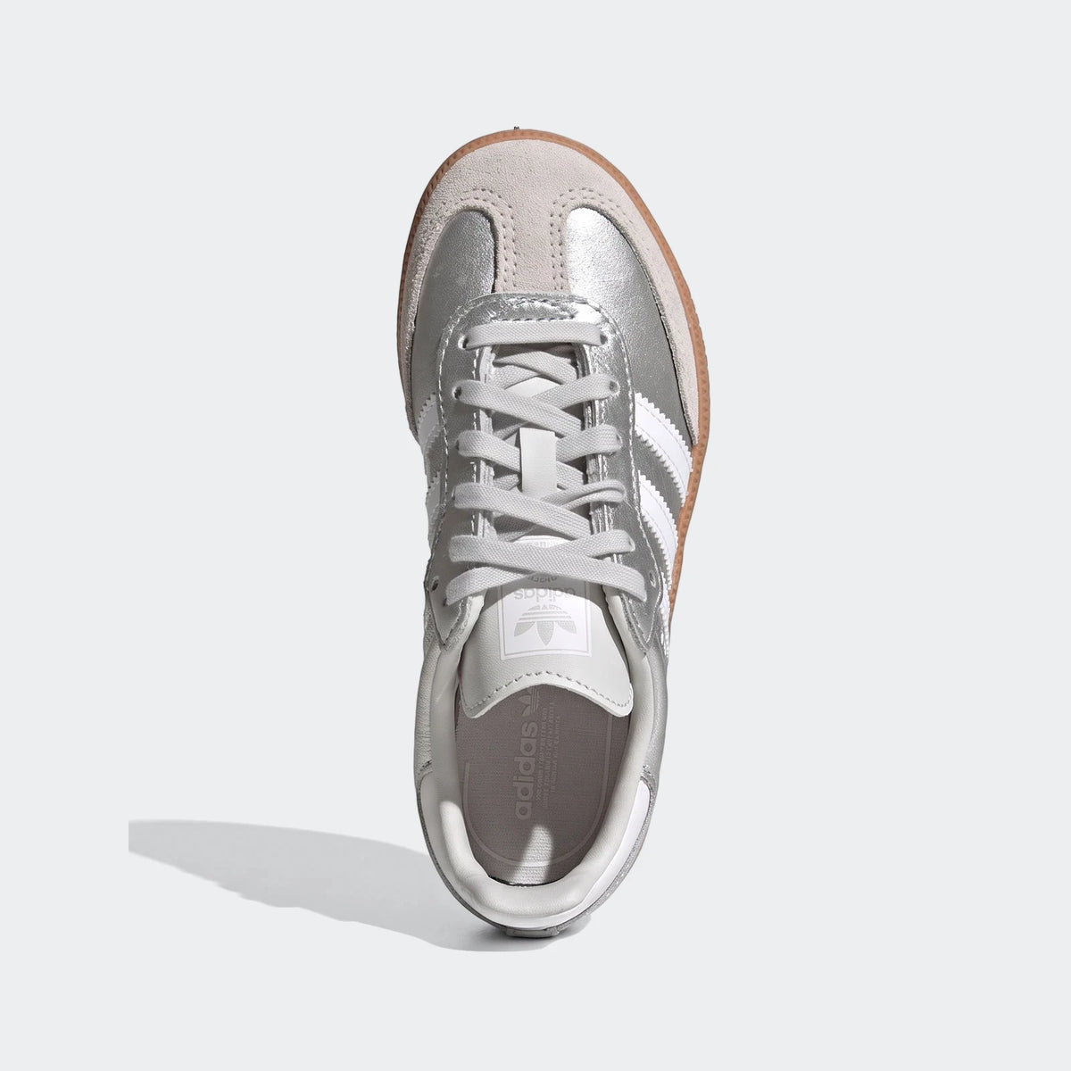 Top-down view of a single silver metallic Adidas Samba Og shoe with white stripes and a light brown gum sole.