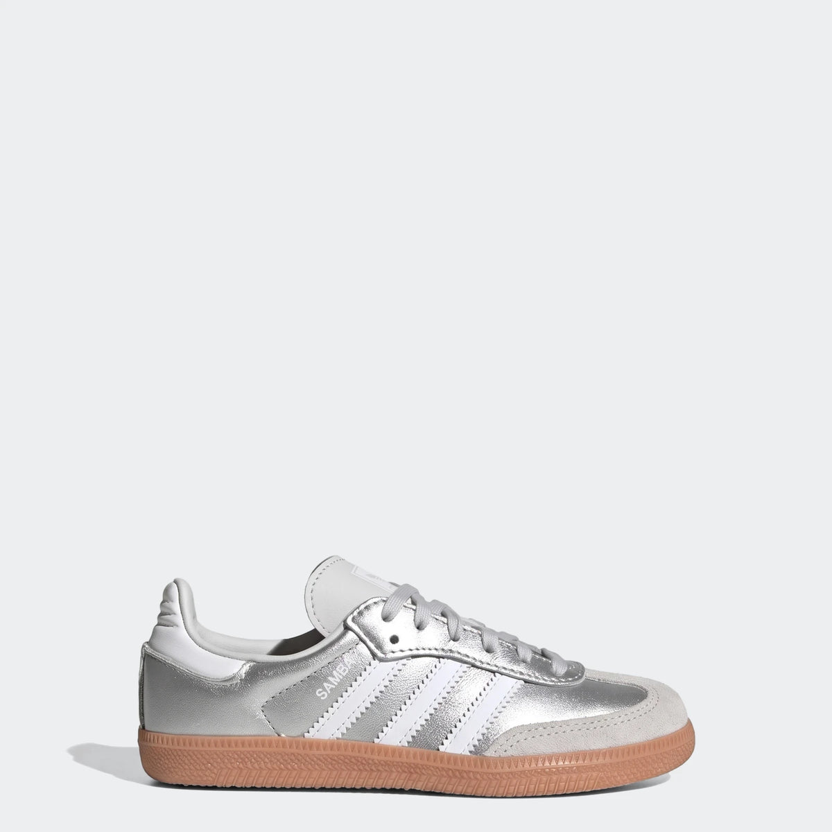 Silver Adidas Samba Og athletic shoes with white stripes and a gum sole, shown from a side view.