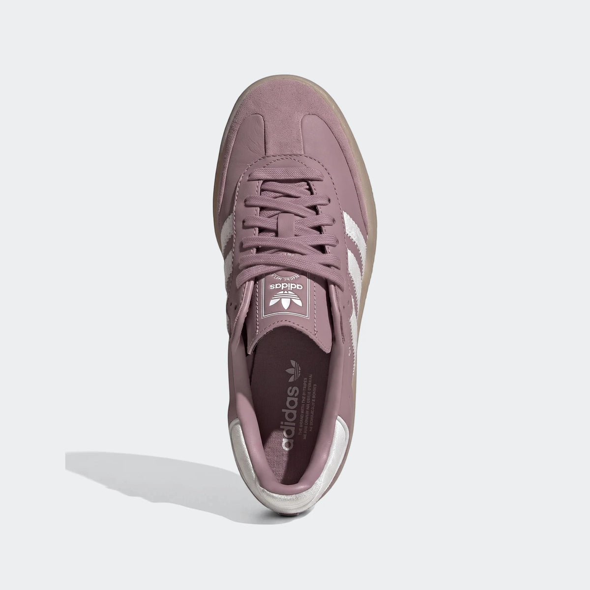 Pink Adidas Sambae shoes with white stripes and a gum sole, viewed from directly above on a white background.