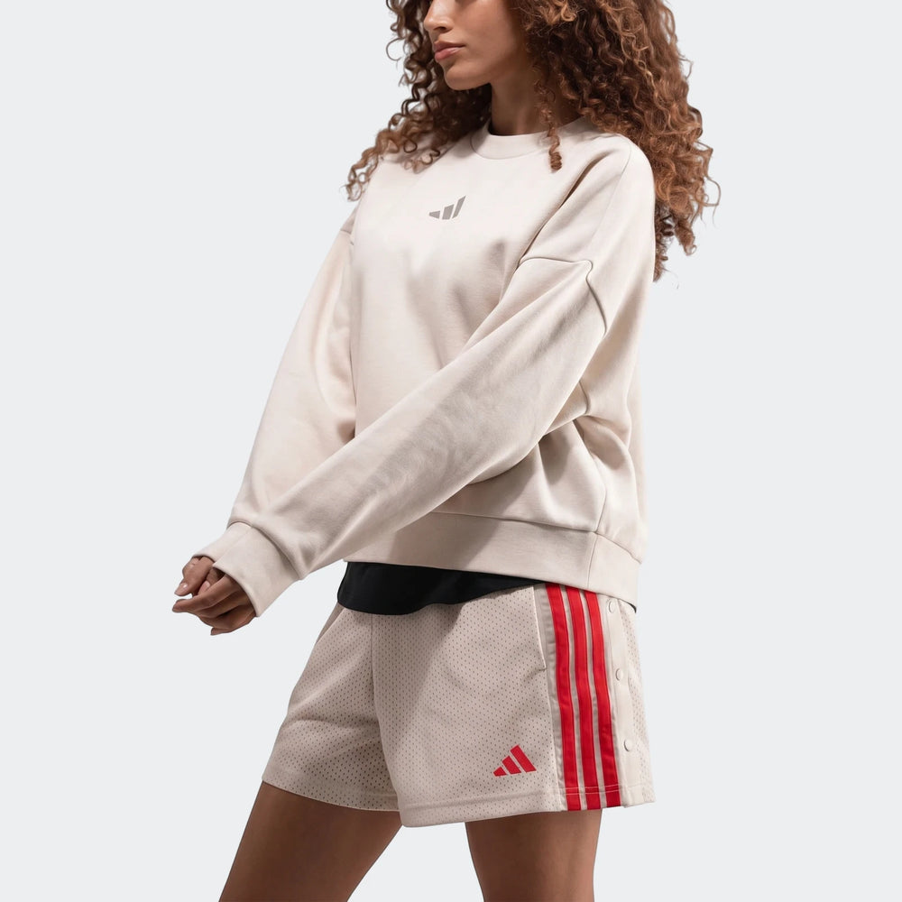 Off-white Adidas Slim Fleece Crew Sweatshirt paired with matching mesh shorts featuring bold red stripes, modeled from the