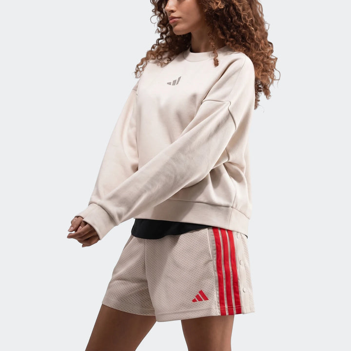 Off-white Adidas Slim Fleece Crew Sweatshirt paired with matching mesh shorts featuring bold red stripes, modeled from the