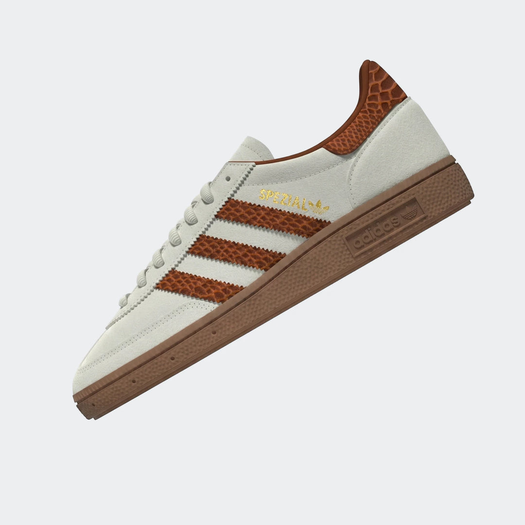 Adidas Spezial sneaker in cream with brown snakeskin stripes and a gum sole, viewed from a side angle.
