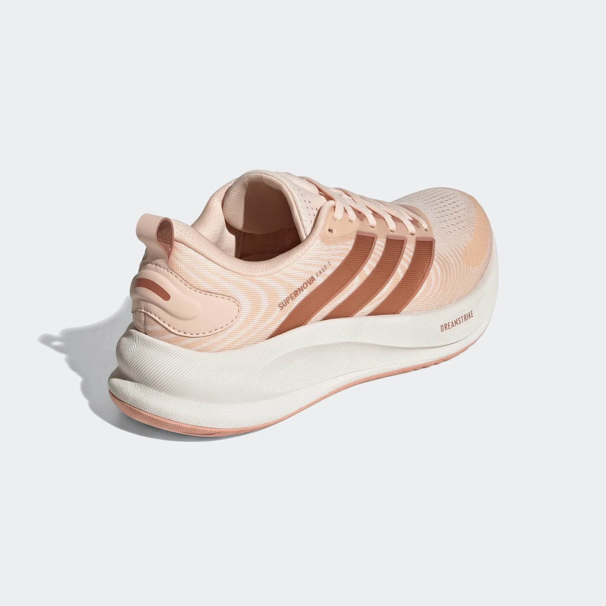 Adidas Supernova Ease 2 running shoes in peach and white, shown from a rear three-quarter view, highlighting the sole and